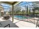 Screened-in pool area with a dining set and pool safety fence at 4201 Oakview Dr, Davenport, FL 33837