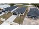 New homes boast modern design, dark roofs, and contrasting paved driveways in a residential area at 59 W 10Th St, Apopka, FL 32703