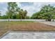 View of the backyard with a new patio area and fresh landscaping, surrounded by lush trees at 59 W 10Th St, Apopka, FL 32703