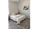 Cozy bedroom with a queen-size bed dressed in white bedding, complemented by a patterned rug and artwork at 59 W 10Th St, Apopka, FL 32703