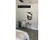 Neutral bedroom with modern art, chair, and side table at 59 W 10Th St, Apopka, FL 32703
