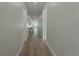 Bright hallway with wood-style flooring that leads to other rooms of the house at 59 W 10Th St, Apopka, FL 32703