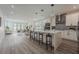 Open-concept kitchen with an island bar, stainless appliances, and modern fixtures at 59 W 10Th St, Apopka, FL 32703
