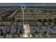Aerial view of a residential neighborhood featuring similar two-story homes, green spaces, and community lakes at 8951 Amelia Downs Trl, Kissimmee, FL 34747