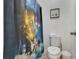 Bright bathroom featuring shower with fireworks shower curtain and white toilet at 8951 Amelia Downs Trl, Kissimmee, FL 34747