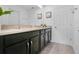 Bathroom featuring dual sinks on dark vanity with light countertop and white doors at 8951 Amelia Downs Trl, Kissimmee, FL 34747
