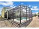 The enclosed pool area features a hot tub and screened enclosure providing a private outdoor oasis at 8951 Amelia Downs Trl, Kissimmee, FL 34747