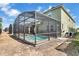 Enclosed pool area with brick trim and a screened enclosure offering a private outdoor space at 8951 Amelia Downs Trl, Kissimmee, FL 34747