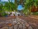 Charming backyard with stone pathway leading to patio, lush landscaping, and a cozy outdoor space at 1145 Utah Blvd, Orlando, FL 32803