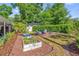 Landscaped backyard with mulch, planting beds, and a seating area with chairs around a fire pit at 1145 Utah Blvd, Orlando, FL 32803