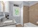 Updated bathroom featuring granite counters, tiled shower with decorative trim, and natural light at 1145 Utah Blvd, Orlando, FL 32803