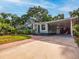 Well-maintained home exterior with charming curb appeal, a covered carport, and lush landscaping at 1145 Utah Blvd, Orlando, FL 32803