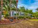 Landscaped exterior view with walkway, green shrubs, and colorful artificial flowers for a vibrant touch at 1145 Utah Blvd, Orlando, FL 32803