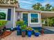 Inviting front entrance with blue door, brick path, and colorful potted plants adding charm at 1145 Utah Blvd, Orlando, FL 32803