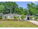 Charming gray home with manicured landscaping and a convenient carport, showcasing curb appeal at 1145 Utah Blvd, Orlando, FL 32803