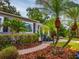 Charming home with lush landscaping, brick walkway, and palm trees enhancing its curb appeal at 1145 Utah Blvd, Orlando, FL 32803