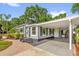 Charming home featuring a carport, gray siding, dark shutters, well-maintained landscaping, and a brick walkway at 1145 Utah Blvd, Orlando, FL 32803