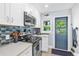 Galley style kitchen featuring stainless appliances, white cabinetry, and outdoor access at 1145 Utah Blvd, Orlando, FL 32803