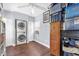 Functional laundry area featuring a stacked washer/dryer, storage cabinets, and natural light at 1145 Utah Blvd, Orlando, FL 32803