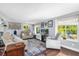 Bright living room with hardwood floors, comfortable seating, and large windows offering backyard views at 1145 Utah Blvd, Orlando, FL 32803