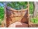 Private outdoor shower with wood enclosure, brick flooring, and convenient shelving at 1145 Utah Blvd, Orlando, FL 32803