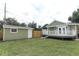 Spacious backyard featuring a detached shed, green lawn and access to the home's back deck at 1312 7Th St, St Cloud, FL 34769