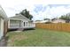 Expansive backyard with green grass, deck, and a charming home exterior at 1312 7Th St, St Cloud, FL 34769