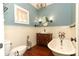Charming bathroom with a clawfoot tub, custom vanity, and elegant fixtures at 1312 7Th St, St Cloud, FL 34769