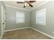 This cozy bedroom offers neutral walls, carpet flooring and a ceiling fan at 1312 7Th St, St Cloud, FL 34769