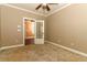 Cozy bedroom has plush carpet and a door leading to an adjacent room at 1312 7Th St, St Cloud, FL 34769
