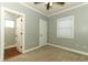 Comfortable bedroom includes an attached bathroom with neutral wall and wood flooring at 1312 7Th St, St Cloud, FL 34769