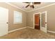 Neutral bedroom with standard window, plush carpet and a door leading to another room at 1312 7Th St, St Cloud, FL 34769