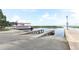 Concrete boat launch and long pier into lake with riverboat in the distance at 1312 7Th St, St Cloud, FL 34769