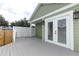 Outdoor deck area featuring a wooden fence and double glass doors to the house at 1312 7Th St, St Cloud, FL 34769