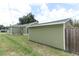 Exterior view of the house and detached garage showing lawn and house siding at 1312 7Th St, St Cloud, FL 34769