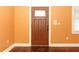 Elegant wood front door with stained glass and dark wood floors at 1312 7Th St, St Cloud, FL 34769
