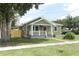 Well-kept home featuring a cozy front porch and lush green landscaping at 1312 7Th St, St Cloud, FL 34769