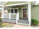 Inviting front porch with white railings and a classic wood front door at 1312 7Th St, St Cloud, FL 34769