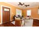 Cozy living room with dark wood floors, neutral furniture, and a decorative front door at 1312 7Th St, St Cloud, FL 34769