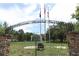 Veterans Memorial Park entrance with flags, greenery and a covered bandstand in the background at 1312 7Th St, St Cloud, FL 34769