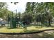 Outdoor playground featuring a climbing wall, slide, and other play equipment at 1312 7Th St, St Cloud, FL 34769