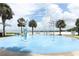 Gathering-friendly splash pad with interactive water features, palm trees, and lake views at 1312 7Th St, St Cloud, FL 34769
