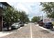 View of a quiet street lined with trees and storefronts, showcasing a peaceful neighborhood ambiance at 1312 7Th St, St Cloud, FL 34769