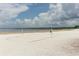 White sand beach volleyball court with white net and blue skies and puffy clouds at 1312 7Th St, St Cloud, FL 34769