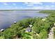 Overhead aerial view of a white house with a dark roof and lake access, complete with a boat dock at 13562 S Lake Mary Jane Rd, Orlando, FL 32832