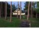 Gorgeous home view with a dock and a backyard that backs onto the lake with mature trees at 13562 S Lake Mary Jane Rd, Orlando, FL 32832