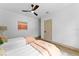 Inviting bedroom with two twin beds, neutral decor, light wood floors, and a ceiling fan at 13562 S Lake Mary Jane Rd, Orlando, FL 32832