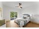 Cozy bedroom with a king-size bed, sliding glass doors to a deck, and comfortable seating at 13562 S Lake Mary Jane Rd, Orlando, FL 32832