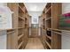 Walk-in closet featuring an organized layout with built-in shelves and drawers at 13562 S Lake Mary Jane Rd, Orlando, FL 32832
