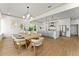 Dining area featuring a wooden table with seating for eight and views to the kitchen at 13562 S Lake Mary Jane Rd, Orlando, FL 32832